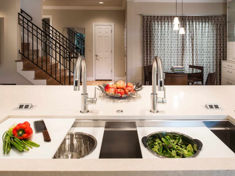 Tulsa kitchen design and remodel featuring a large island with a Galley Workstation, a quartz countertop, and an induction cooktop.