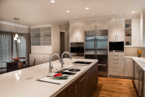 Tulsa island kitchen remodel, brown cabinet storage, Galley sink, Wolf induction cooktop, quartz counters, white flat panel cabinets, stainless Sub-Zero Wolf, Miele appliances Tulsa kitchen remodel
