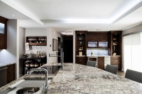 Kitchen design large island granite counter-top, Galley Workstation, bar area frosted glass wall cabinet storage, raised ceiling, island seating Tulsa kitchen remodel