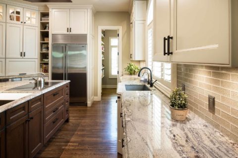Kitchen island cabinet storage, marble counter-tops, Wolf induction cooktop, undermount sink, subway tile backsplash, Sub-Zero full size freezer refrigerator, open shelves Tulsa kitchen remodel