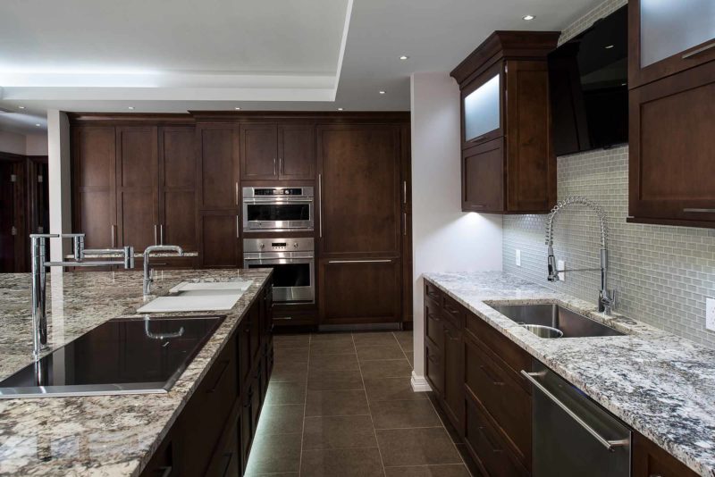 Tulsa kitchen island remodel Galley Workstation kitchen sink, Thermador induction cooktop, cleanup sink, Monogram ovens, granite counter-top, ceramic tile backsplash Tulsa kitchen remodel