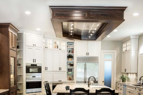 Kitchen island vent hood, marble counters, Wolf ovens, Sub-Zero freezer refrigerator, open shelf storage, cream cabinets, island seating Tulsa kitchen remodel