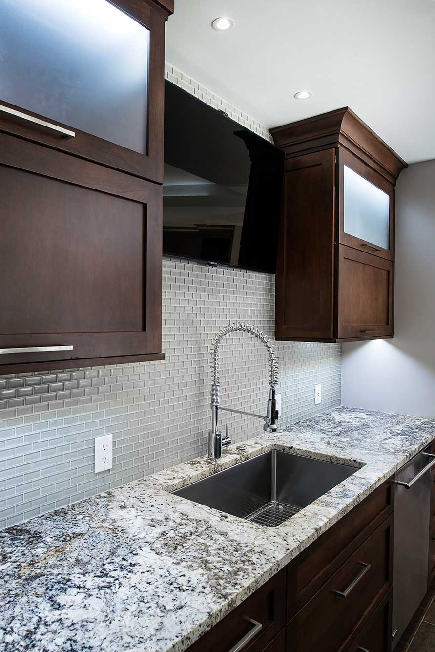 Kitchen remodel underemount sink, ceramic tile backsplash, brown pull-up wall cabinet storage, frosted glass, stainless dishwasher Tulsa kitchen design