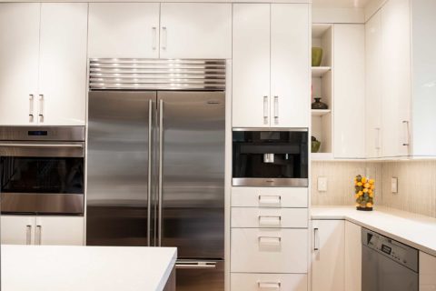 Tulsa kitchen remodel cabinets, stainless Sub-Zero refrigeration, Wolf oven, Meile coffee, white cabinet flat panel drawer storage Tulsa kitchen remodel