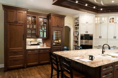 Tulsa kitchen wine center, wood flooring, large island, ceiling vent hood, Galley Workstation, marble counters, white tall cabinet storage, Sub-Zero Wolf appliances Tulsa kitchen remodel