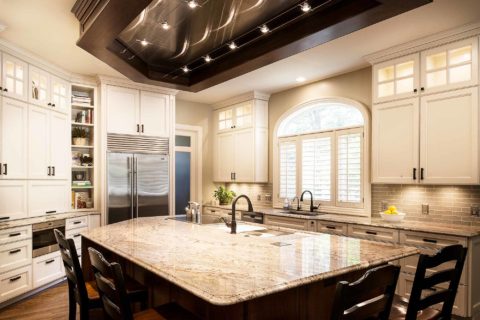 Large marble kitchen island, Galley Workstation, ceiling vent hood, Wolf induction cooktop, Sub-Zero freezer refrigerator, open shelves, Wolf drawer microwave Tulsa kitchen remodel