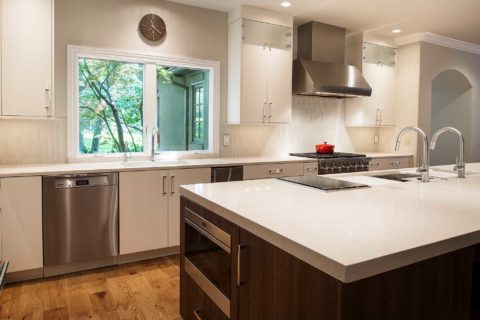 Large open kitchen remodel quartz counter-tops, white flat panel cabinets, stainless dishwasher, large island, drawer microwave, induction cooktop, Galley Workstation Tulsa kitchen remodel