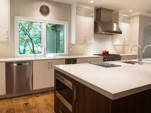 Large open kitchen remodel quartz counter-tops, white flat panel cabinets, stainless dishwasher, large island, drawer microwave, induction cooktop, Galley Workstation Tulsa kitchen remodel