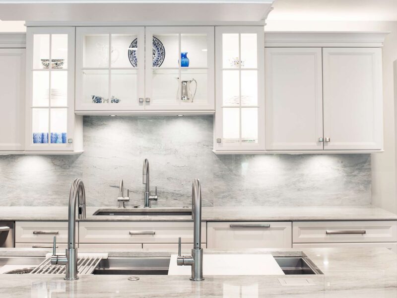 Tulsa kitchen remodel featuring lighted wall cabinet storage, a Galley Workstation with an under mount sink, and a matching counter and backsplash.
