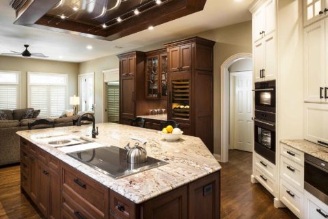 Old world Tulsa kitchen, Galley Workstation, Wolf induction cooktop, marble counter top, ceiling vent hood, wood floors, Wolf double ovens, Sub-Zero tall wine refrigerator Tulsa kitchen design and remodel