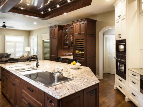 Old world Tulsa kitchen, Galley Workstation, Wolf induction cooktop, marble counter top, ceiling vent hood, wood floors, Wolf double ovens, Sub-Zero tall wine refrigerator Tulsa kitchen design and remodel