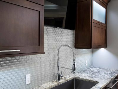Undermount kitchen sink, ceramic tile backsplash, dark brown pull up wall cabinet storage, frosted glass fronts, stainless dishwasher Kitchen Ideas Tulsa kitchen design and remodel