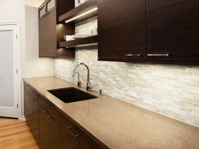 Tulsa kitchen remodel featuring an undermount cleanup kitchen sink, open shelves, a stone backsplash, a quartz countertop, and bamboo cabinet storage.