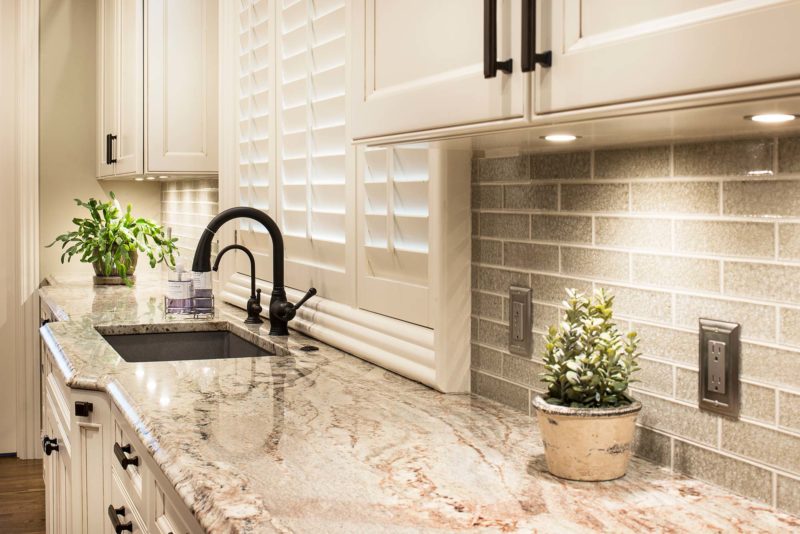 Undermount sink kitchen remodel marble counter-top, subway tile backsplash, cream kitchen cabinet storage Tulsa kitchen design and remodel