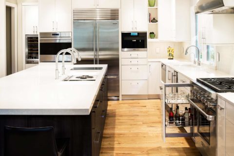 White kitchen base pullout, drawer storage, oils spices, Sub-Zero refrigerator freezer, Wolf ovens, Miele coffee, Wolf gas range, large island Galley Workstation Tulsa kitchen remodel