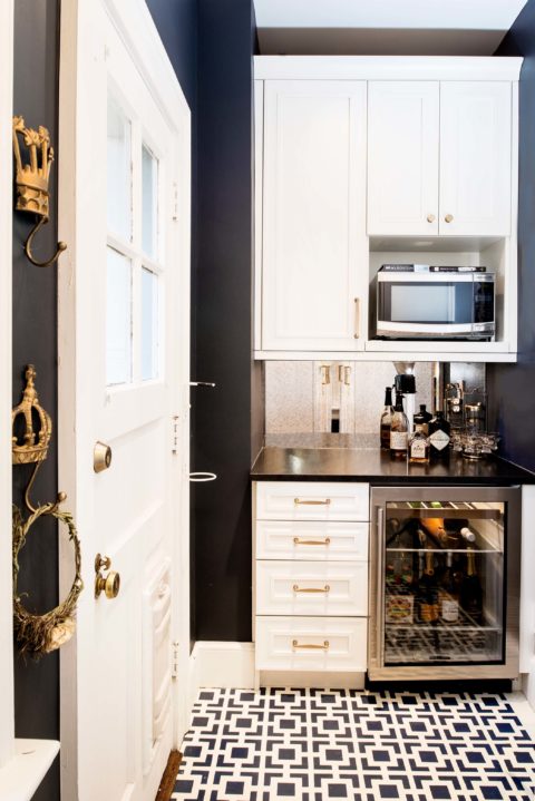 Tulsa kitchen remodel featuring a beverage space with a mirror backsplash, a wall microwave, and a stainless steel under counter beverage refrigerator.