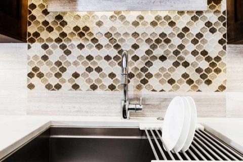 Tulsa kitchen remodel featuring a Galley Workstation clean-up sink, decorative tile backsplash, and Caesarstone countertop.