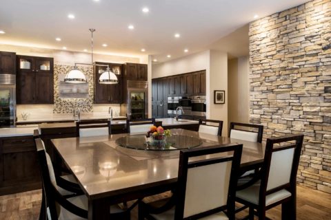 Tulsa kitchen rolling table, decorative pendants, large island, stone wall, Sub-Zero freezer refrigerators, Galley sink workstation, Wolf convection steam ovens Tulsa kitchen remodel