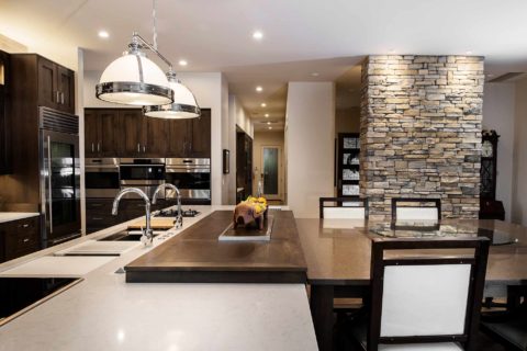 Open Tulsa kitchen island, rollout wood table seating, pop-up television, quartz counter, pendant lights, Wolf convection steam ovens Kitchen Ideas Tulsa kitchen remodel