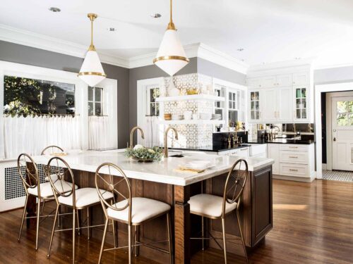 Traditional Midtown Tulsa kitchen remodel featuring a Galley Workstation, refinished wood floors, an Ann Sacks Nottingham backsplash, professional stainless steel appliances, and pendant lights.