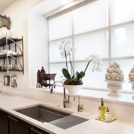 Tulsa kitchen remodel with Galley Workstation clean-up kitchen sink white Caesarstone quartz counter-top, open shelves and rich brown cabinet storage