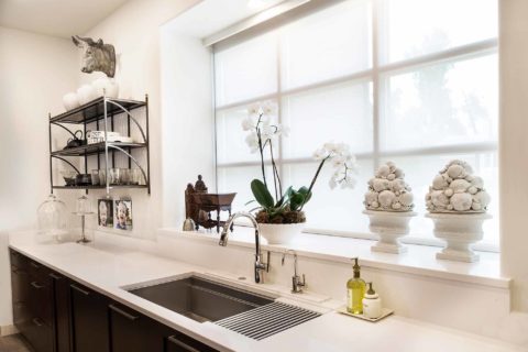 Tulsa kitchen remodel with Galley Workstation clean-up kitchen sink white Caesarstone quartz counter-top, open shelves and rich brown cabinet storage