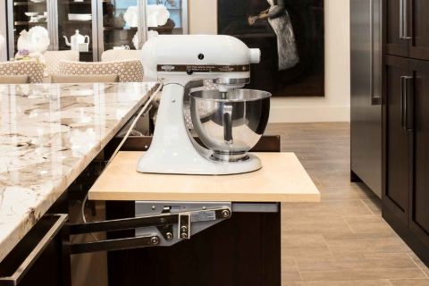 Classy Tulsa kitchen remodel island incorporating pullout-mixer storage and marble counter-top