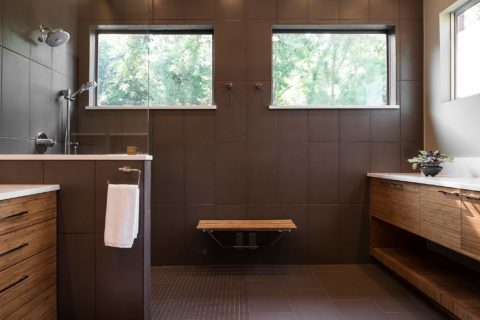 Contemporary Tulsa master bath design and remodel with walk-in shower, wood bench seating, medium brown wood grain base vanity storage, quartz counter-tops and glass partition
