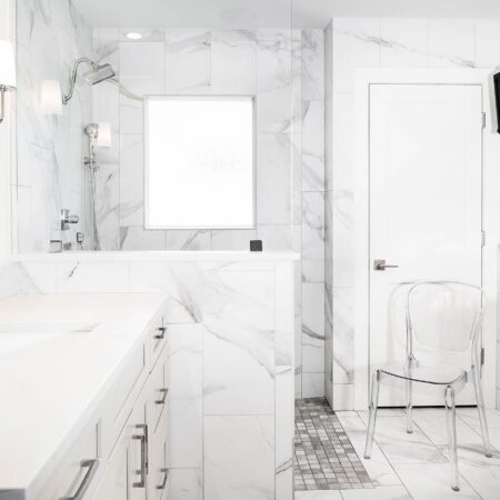 Modern Tulsa bathroom with vanity base cabinet drawer storage, walk-in shower, large tile walls and wall mounted television