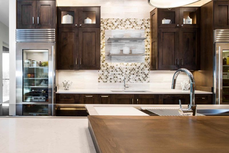 Modern south Tulsa kitchen with Galley Workstation kitchen sinks, open shelves decorative tile backsplash, Sub-Zero tall refrigerators and brown cabinet storage