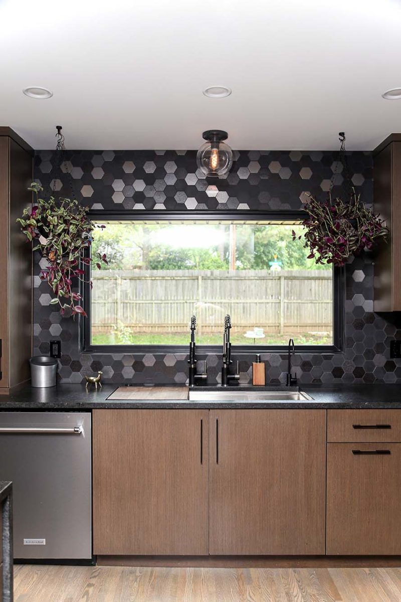 Kitchen design and remodel Tulsa flat panel cabinets, stainless dishwasher, sink workstation, tile backsplash and decorative pendant light