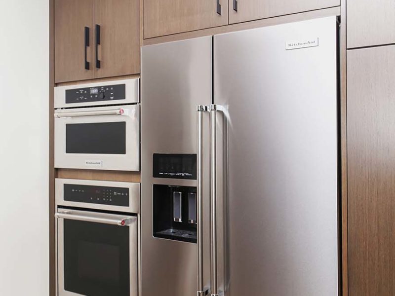 Tulsa kitchen tall cabinet storage and Kitchenaid stainless microwave and oven and stainless side-by-side freezer refrigerator