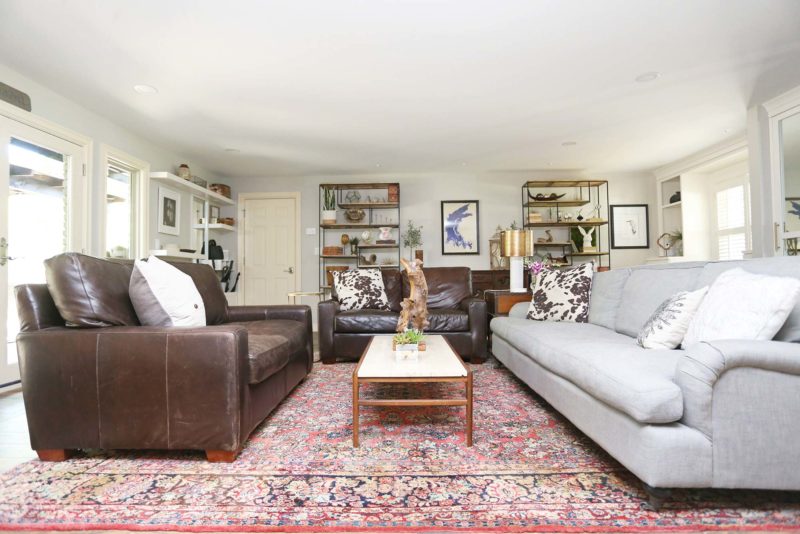 Open spacious remodeled Tulsa living room seating and entertainment space with decorative shelves and seating area