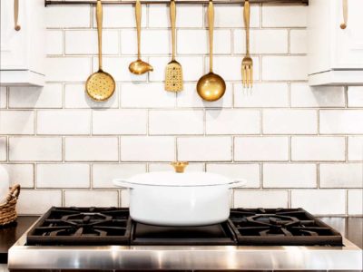 Traditional Tulsa kitchen with stainless Thermador professional gas rangetop, vent hood, accented by subway tile backsplash