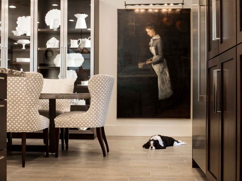 Tulsa kitchen remodel featuring an adjoining dining room, a table, and tall glass storage for fine china, creating a seamless and elegant living space.