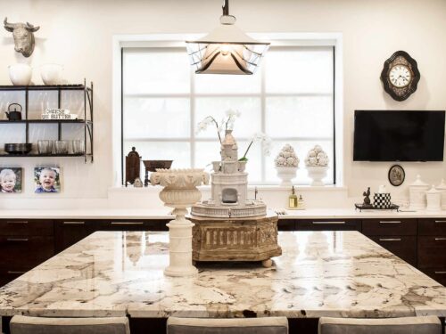 Tulsa kitchen remodel with quartzite and quartz counter-tops, island seating, rich-brown base cabinet storage and modern designed pendant lights