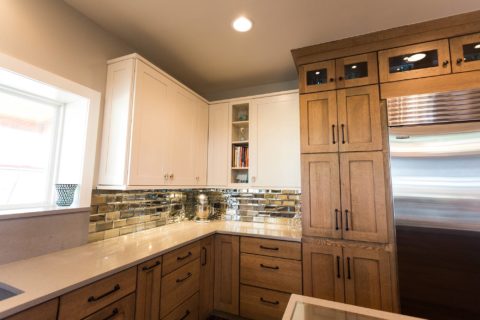 Tulsa kitchen design and remodel featuring cabinet storage, a tile backsplash, a tall pantry, a Sub-Zero refrigerator and freezer, quartz counters, and drawer storage.