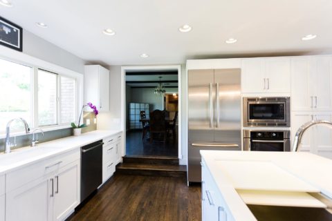 Tulsa kitchen remodel featuring kitchen storage, an under mount sink, a quartz counter top, a Galley Workstation, a formal dining room entry, and a Bosch french door refrigerator and ovens.