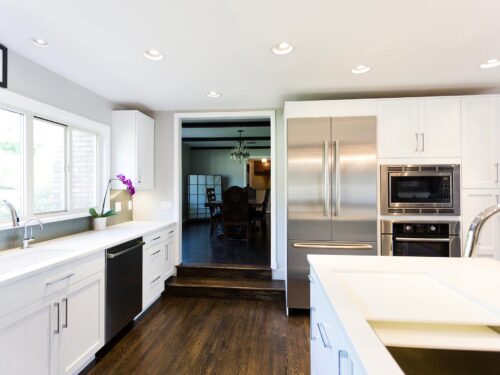 Tulsa kitchen remodel featuring kitchen storage, an under mount sink, a quartz counter top, a Galley Workstation, a formal dining room entry, and a Bosch french door refrigerator and ovens.