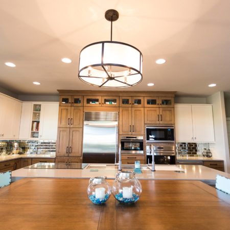 Open ranch kitchen design, large island, pendant lighting, tall storage, Sub-Zero Wolf appliances, table seating Tulsa kitchen design and remodel