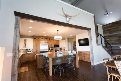 Tulsa kitchen design and remodel featuring an open ranch kitchen with an entry, dining, and living space, a large island with seating, and kitchen cabinet storage.