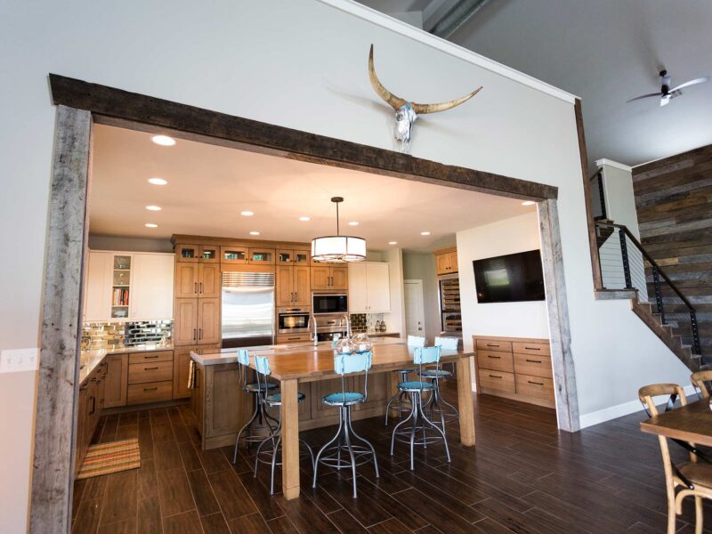Tulsa kitchen design and remodel featuring an open ranch kitchen with an entry, dining, and living space, a large island with seating, and kitchen cabinet storage.
