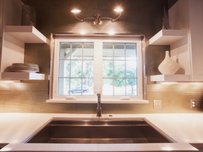 Galley Workstation undermount sink, white counters, tile backsplash, floating shelves and wall sconce Kitchen Ideas Tulsa kitchen remodel