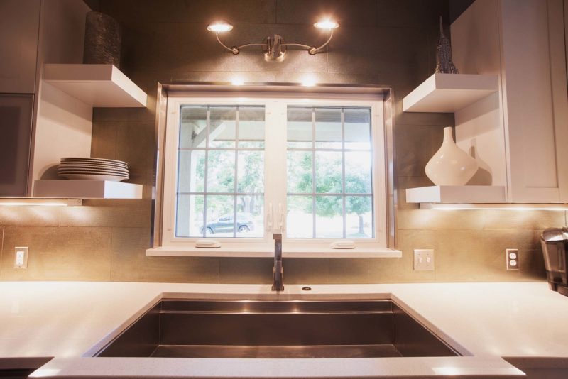 Galley Workstation undermount sink, white counters, tile backsplash, floating shelves and wall sconce Kitchen Ideas Tulsa kitchen remodel