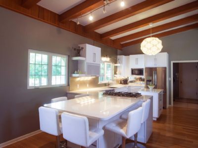 Kitchen peninsula seating, vaulted ceilings, pendant lighting, white countertops, open shelves, gas cooktop, wood floors Kitchen Ideas Tulsa kitchen remodel