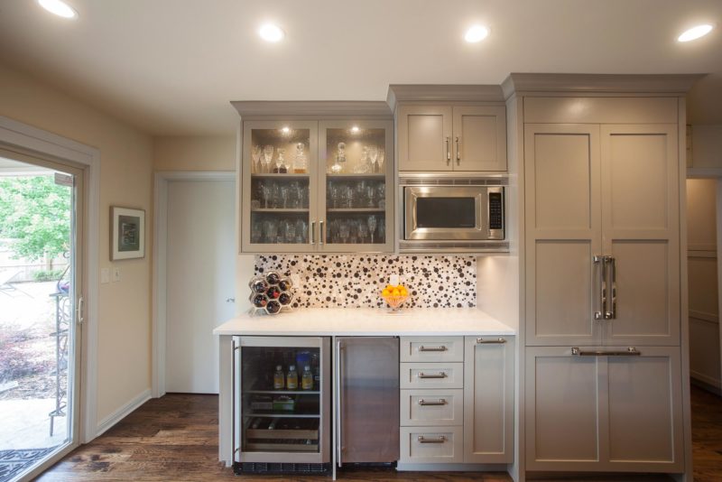 White kitchen beverage space, microwave, under counter refrigerator, ice maker, tile backsplash, wall cabinets, beaded glass door panels, refrigerator Kitchen Ideas Tulsa kitchen remodel