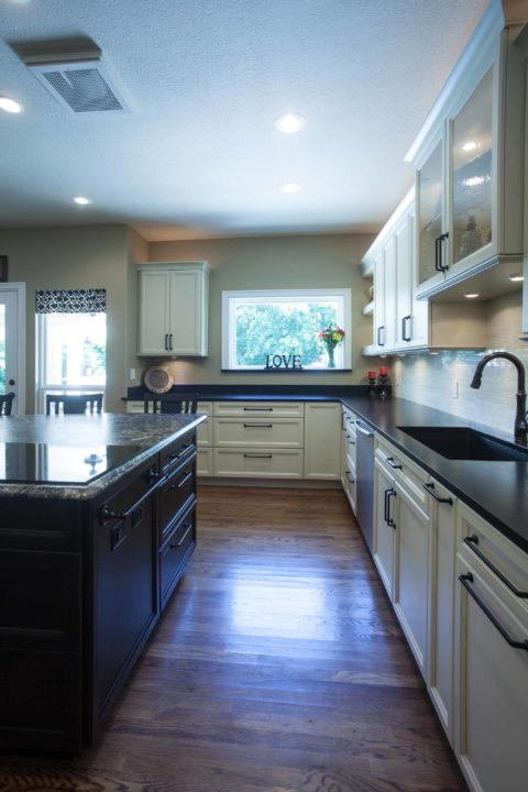 Kitchen island drawer storage, undermount kitchen sink, black counter tops, wood floors Kitchen Ideas Tulsa kitchen remodel