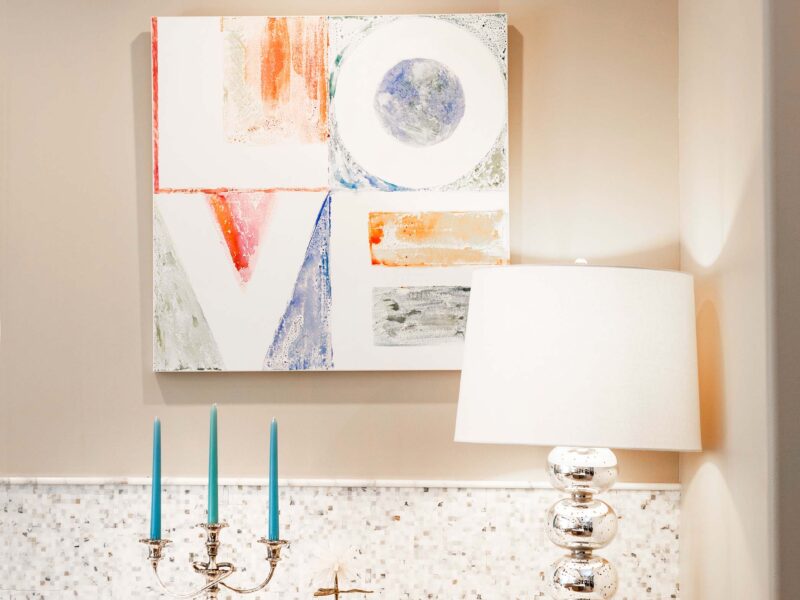 Tulsa kitchen design and remodel featuring an island with drawer storage, an induction cooktop, a prep sink with a recessed cutting board, and a full-size Frigidaire freezer and refrigerator.