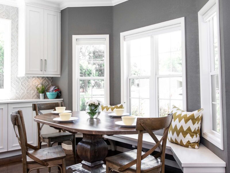 Tulsa kitchen design and remodel featuring a breakfast nook with built-in seating, a bay window, and white cabinet storage.