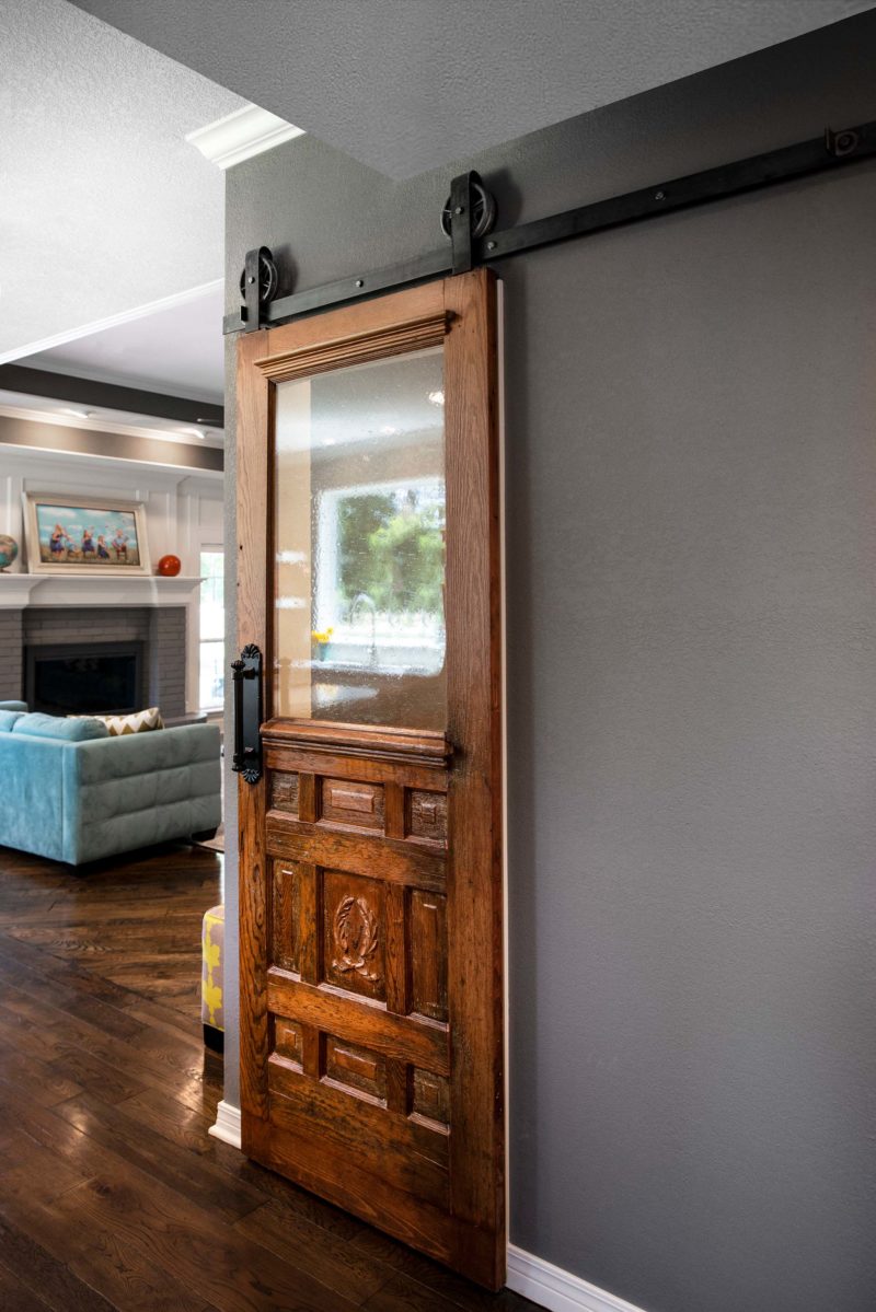 Walk in kitchen pantry with sliding door on rails, open living room space Kitchen Ideas Tulsa kitchen design and remodel
